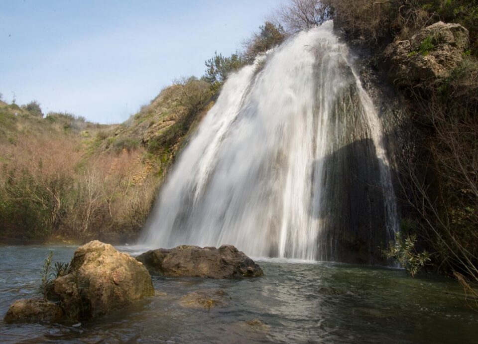 a large waterfall is coming out of the water