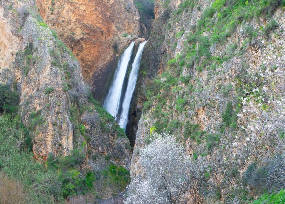 a waterfall in the middle of a canyon